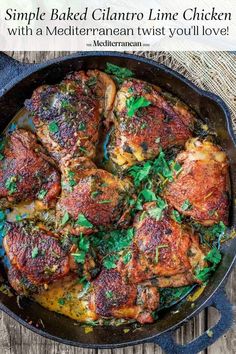 chicken thighs with herbs in a cast iron skillet on top of a wooden table