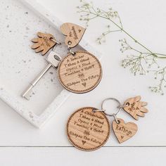 two wooden keychains with engraved names on them