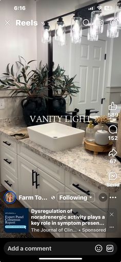 an image of a bathroom with vanity lights on the mirror and sink in front of it