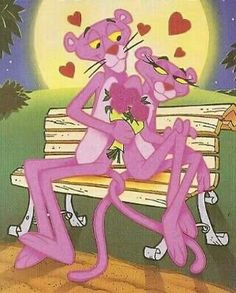 a pink cat sitting on top of a wooden bench next to a person holding a heart