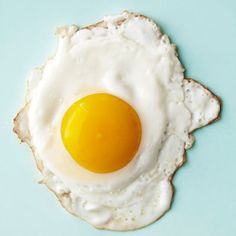 an egg is sitting on top of a piece of bread