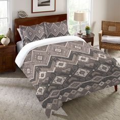 a bed in a bedroom with a brown and white comforter