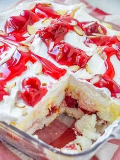 a cake with white and red toppings in a glass dish