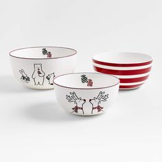 three bowls with designs on them sitting next to each other in front of a white background