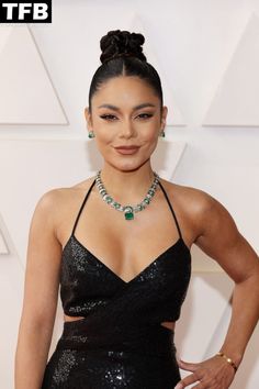 an image of a woman wearing a black dress on the oscars red carpet with her hair in a bun