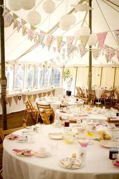 a large tent with tables and chairs set up for a tea party