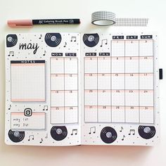 an open planner with music notes on it and a pencil next to it that says may