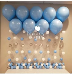 blue and white balloons are on the wall