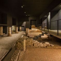 an empty room with stone steps and rocks on the ground in front of some stairs