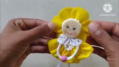 a person holding a yellow flower with a small doll in it