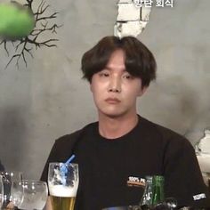 a man sitting at a table with beer glasses