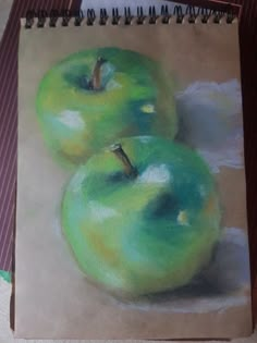 a drawing of three green apples sitting on top of a table