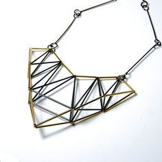 Silver Necklace - This striking triangular pendant is formed from tubes of oxidized sterling silver and 14k gold-filled, joined with thread. It hangs from a chain of handmade links of oxidized sterling silver wire and closes with a hook clasp. Gold Geometric Metal Necklace, Elegant Triangle Metal Jewelry, Modern Geometric Metal Necklace, Minimalist Triangle Metal Necklace, Silver Triangle Metal Necklace, Silver Gold Necklace, Triangle Pendant, Hook Clasp, Circle Necklace