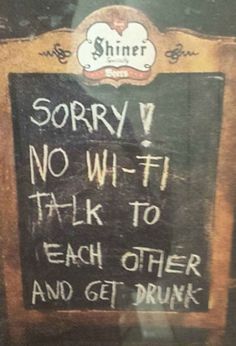 a sign that is on the side of a door saying sorry no wifi talk to each other and get drunk