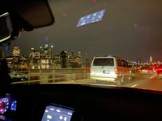 the view from inside a car looking at city lights