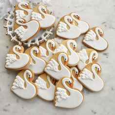 decorated cookies in the shape of swans on a table