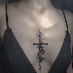 a woman with a cross tattoo on her chest