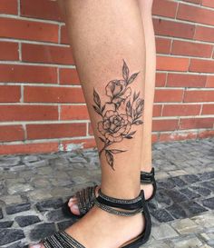 a woman's leg with a flower tattoo on it