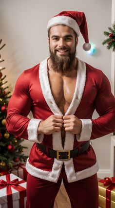 a man dressed as santa claus standing in front of a christmas tree with his hands on his chest