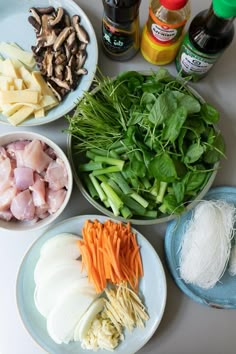 the ingredients are laid out on the table to make this meal, including carrots, spinach, and mushrooms