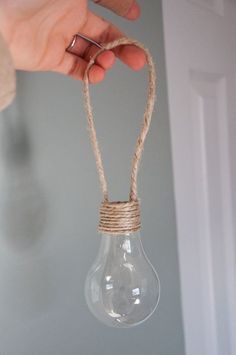 a person holding a light bulb with rope wrapped around it