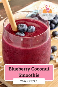 blueberry coconut smoothie in a glass with strawberries on the side and text overlay that reads, blueberry coconut smoothie vegan wpb