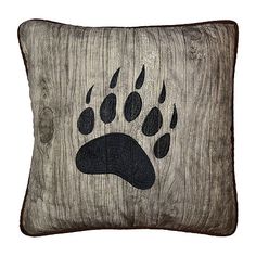 a wooden pillow with an animal's paw painted on it