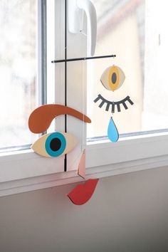 a window sill with an eye and tears hanging from it's side