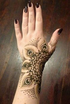 a woman's hand with an intricate design on it