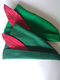 three green and red napkins sitting on top of each other