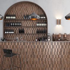 an empty bar with stools and bottles on the shelves