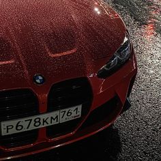 a red sports car parked in the rain