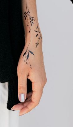 a woman's hand with a tattoo on it