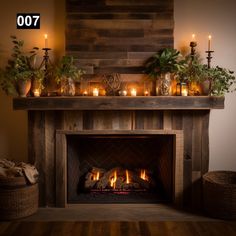 a fire place with candles and potted plants on the mantel over which is lit