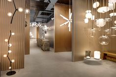 the interior of an office building with wooden walls and lights hanging from it's ceiling