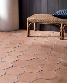 a bench sitting on top of a tiled floor