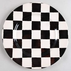 a black and white checkered plate sitting on top of a table