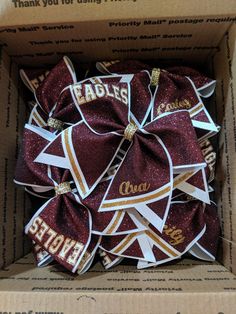 a box filled with maroon and white cheer bows