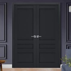 two black doors in a room with purple walls