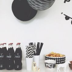 there are many drinks and snacks on the counter next to each other in front of a clock