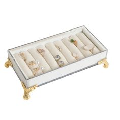 a white and gold jewelry box filled with rings