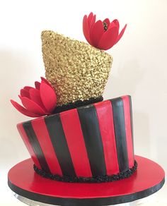 a red and black striped cake with flowers on top