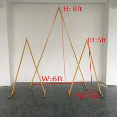 three wooden poles are shown with measurements for each pole in front of the white wall