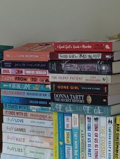 a stack of books sitting on top of a wooden table