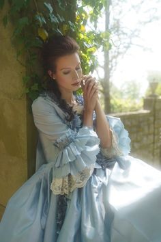 Immerse yourself in the splendor of a bygone era with our Sky Blue Rococo Ball Gown, an exquisite creation crafted for those who covet timeless elegance. This dress is a harmonious blend of the lavishness of the Rococo period and the grandeur of Baroque fashion, designed to enrobe you in a spectacle of courtly allure.The soft sky blue satin fabric drapes gracefully, cascading in sumptuous folds that reflect the light with every movement, embodying the opulent lifestyle of Marie Antoinette hersel Gunne Sax Wedding Dress, Victorian Style Wedding Dress, Antique Wedding Dresses, Victorian Style Wedding, Lace Embellishments, Nontraditional Wedding Dress, Antoinette Dress, Voluminous Skirt, Gothic Wedding Dress