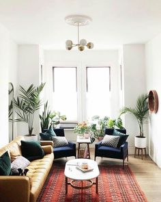 a living room with two couches and a table in front of a window on instagram