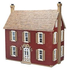 a toy house with windows and shutters on the front, side and top floors