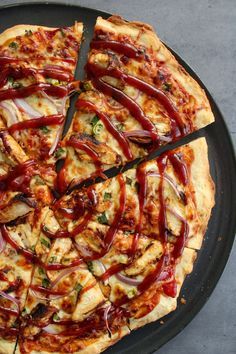 a pizza that has been cut into slices with red sauce and onions on the top