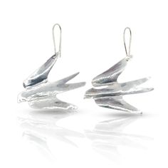 pair of silver bird earrings on white background