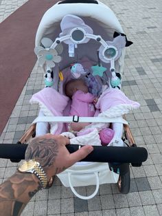 a person is pushing a baby in a stroller